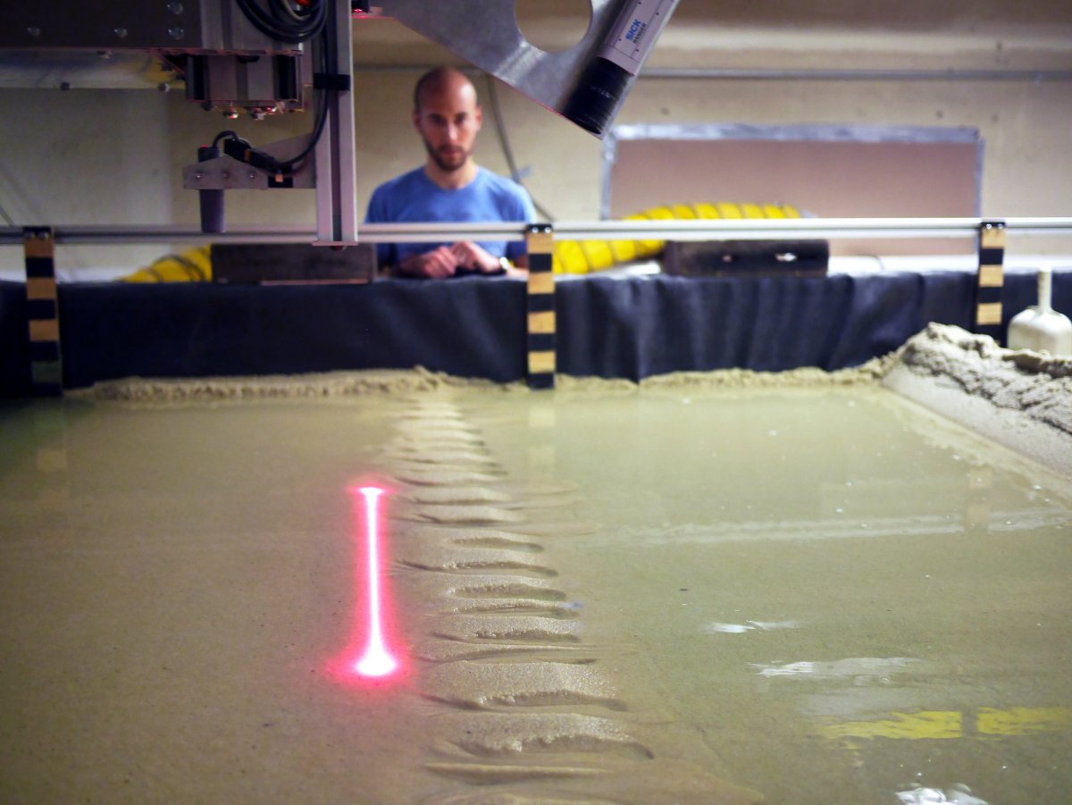Photo of a laser scanner taking topography data in a sediment basin