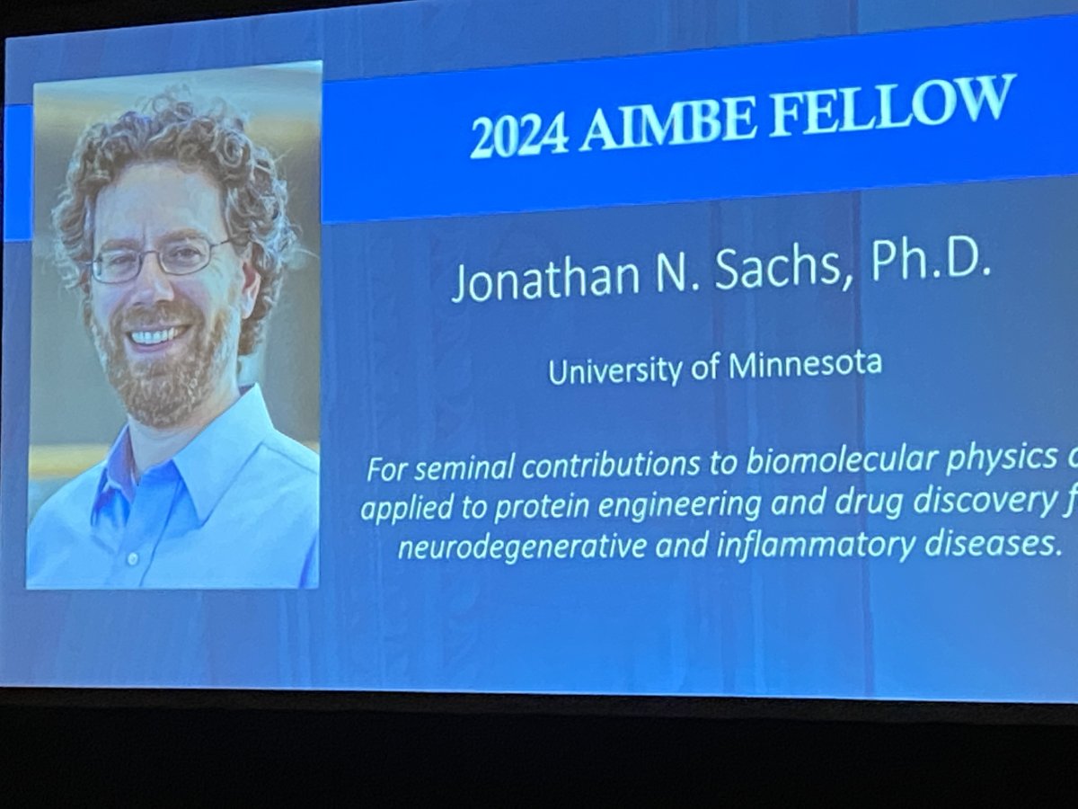 screen at event showing Jonathan Sachs and text announcing his induction into the 2024 Class of the AIMBE College of Fellows