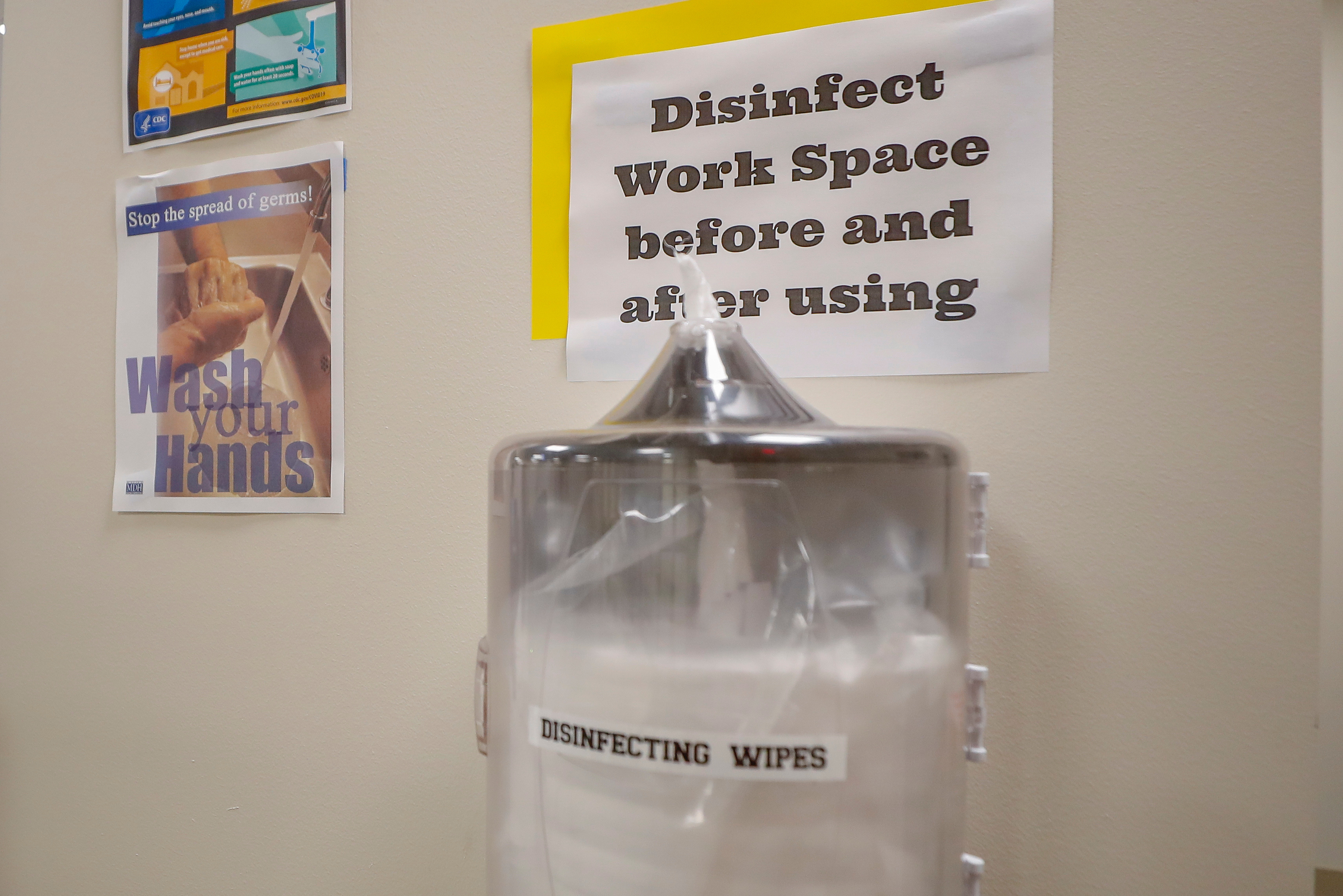 signage reminding people to disinfect a work area