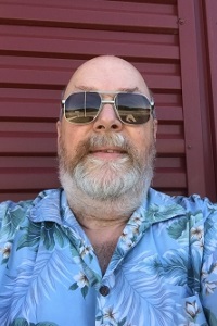 Man wearing very cool shades with a Hawaiian shirt