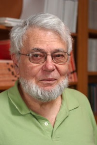 Man wearing green shirt with beard and glasses