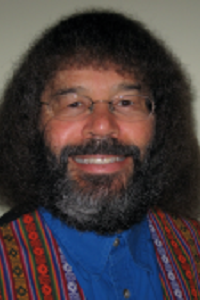 man with big hair and big beard smiling