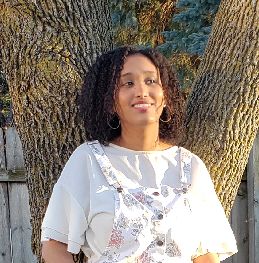 Ruth Mesfin poses next to a tree
