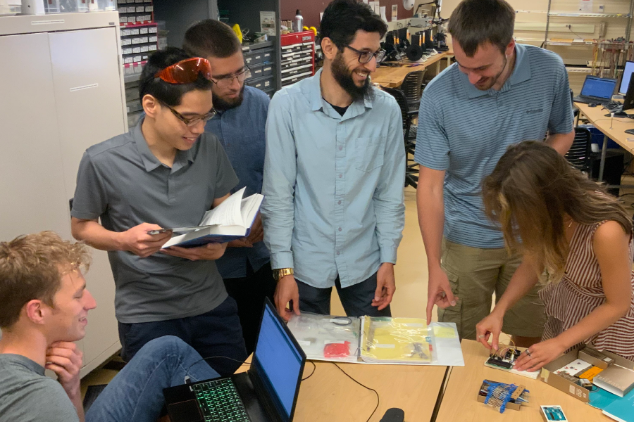 Group of students working on a medical device