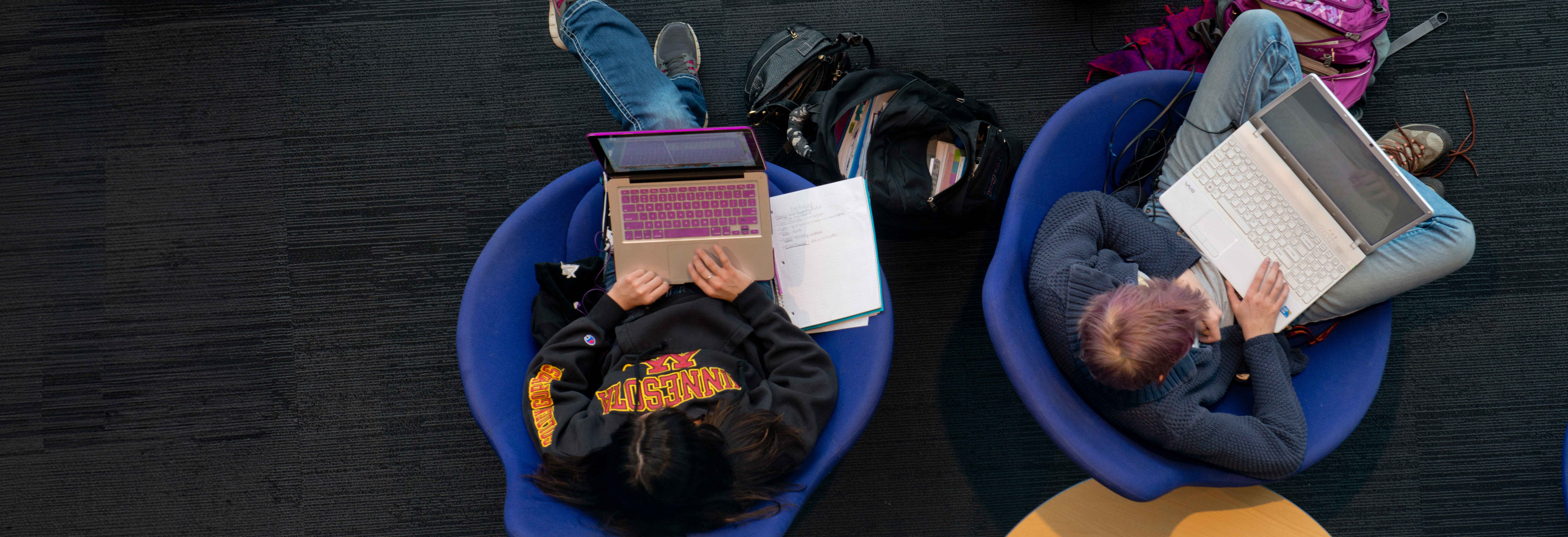 Birds-eye view of two students on computers 