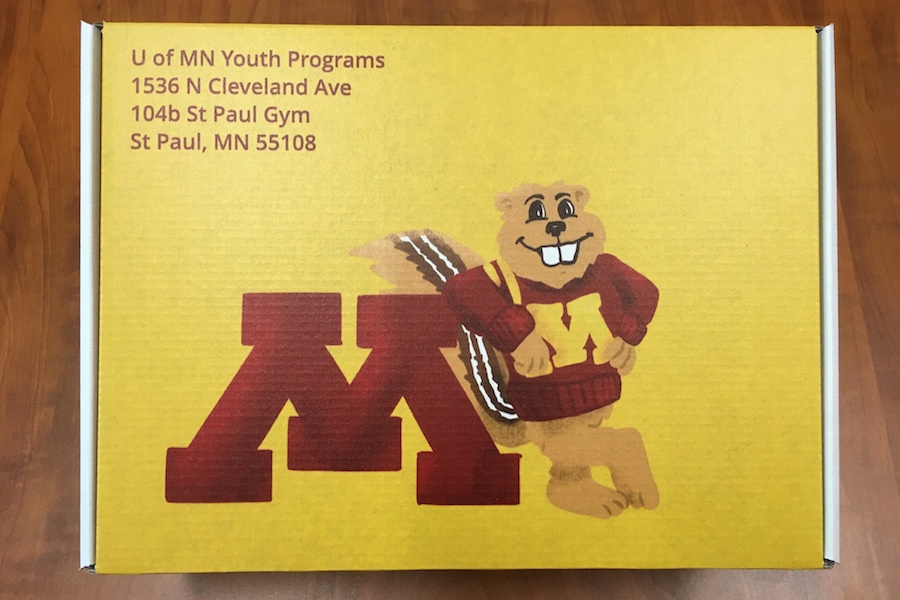 A gold camp box with Goldy Gopher printed on it