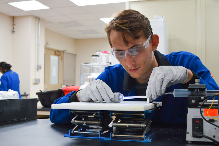 Ph.D. student Matt Hausladen with a soft robot in the lab