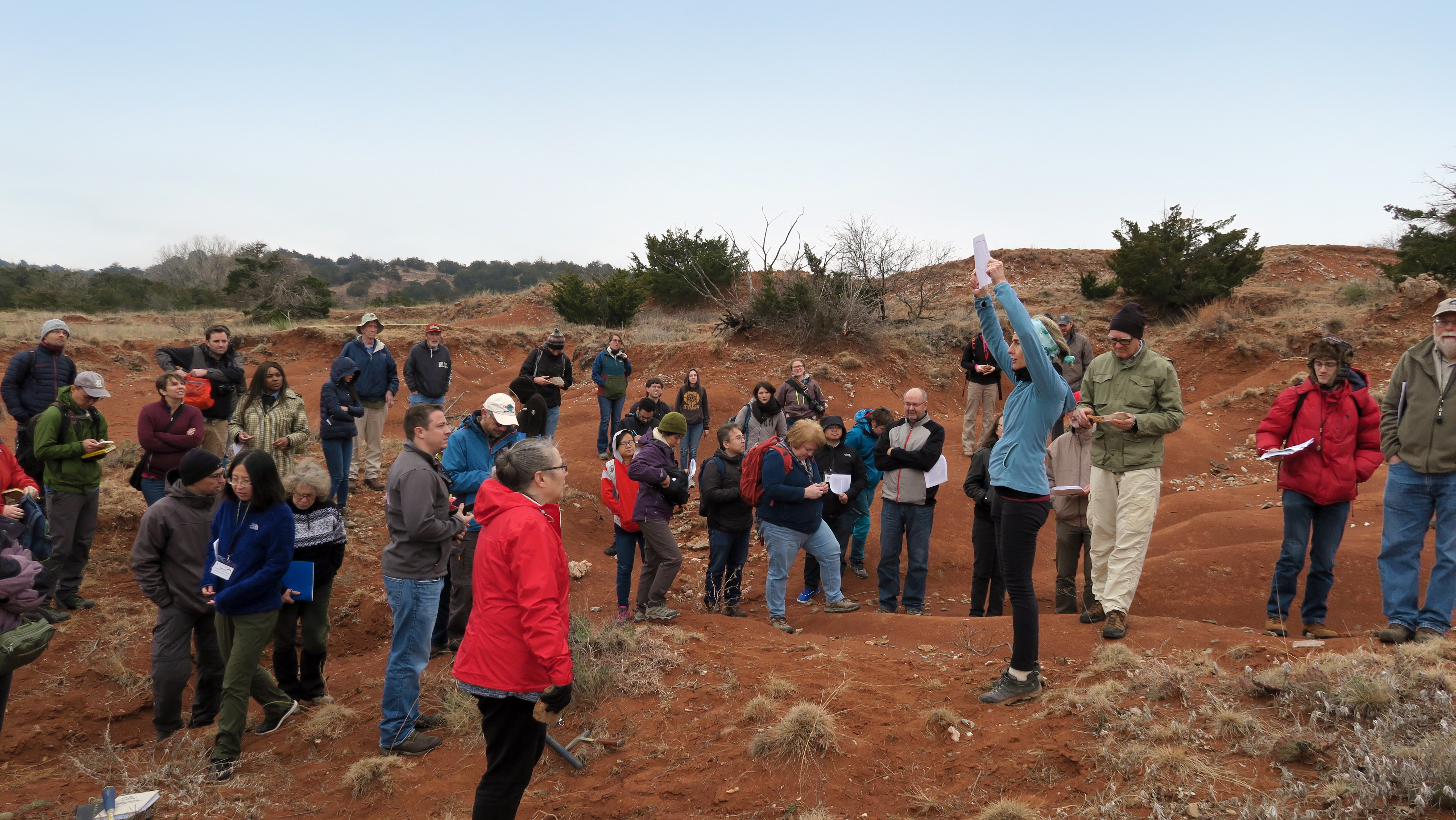 A group of researchers examining a potential site for coring during the Deep Dust workshop in 2019