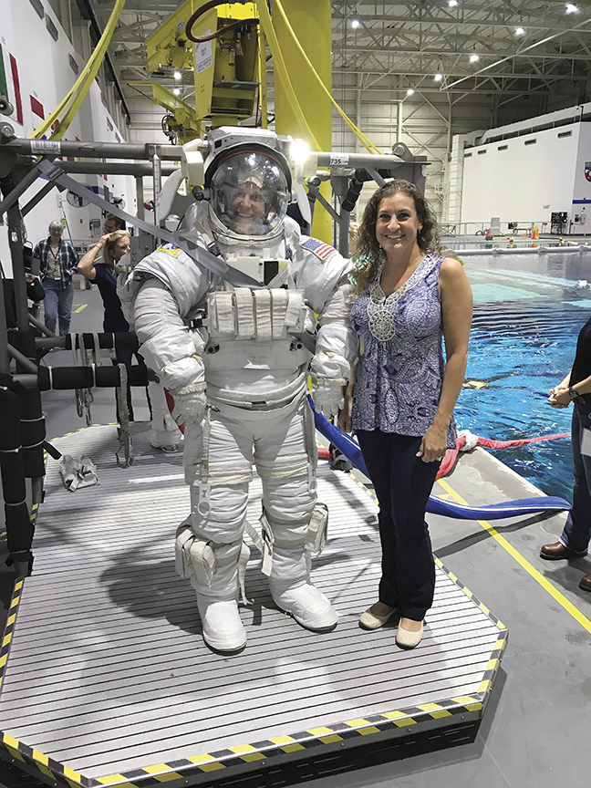 Heather McDonald standing next to an astronaut.