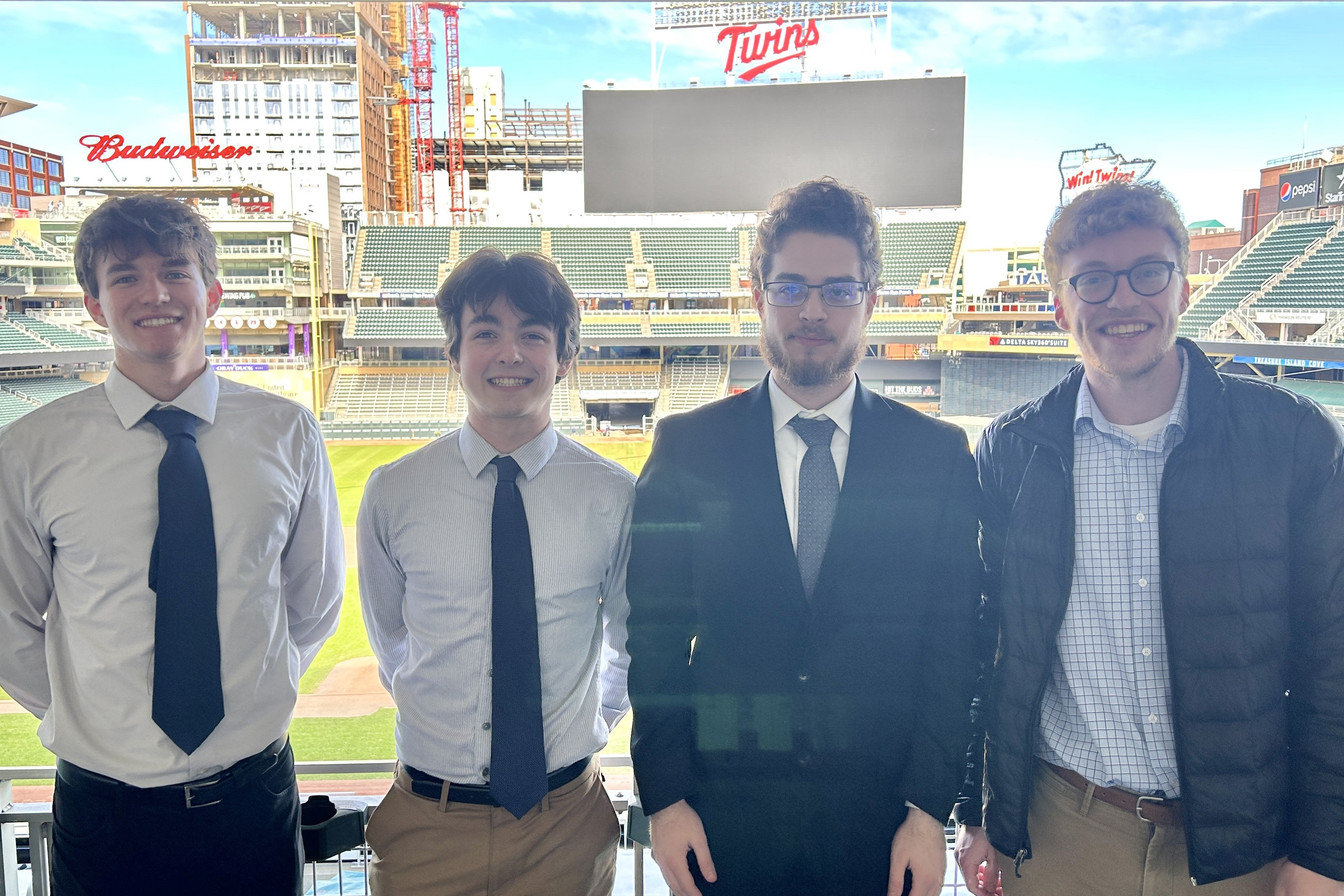 Kennedy Johnson, Charles Hart, Tom Bareket, and Jack Rogers pose together at Target Field