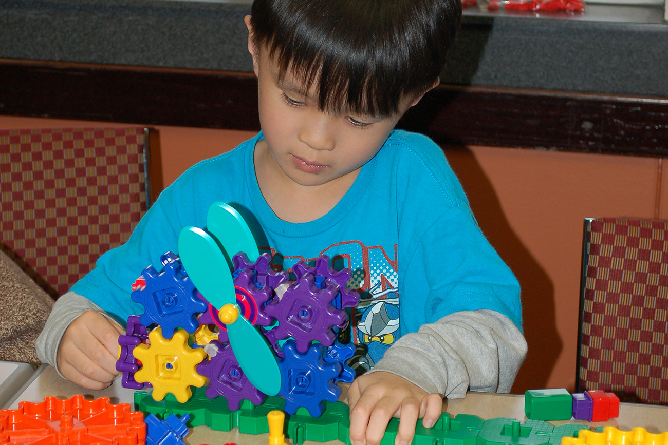 Child playing with gears