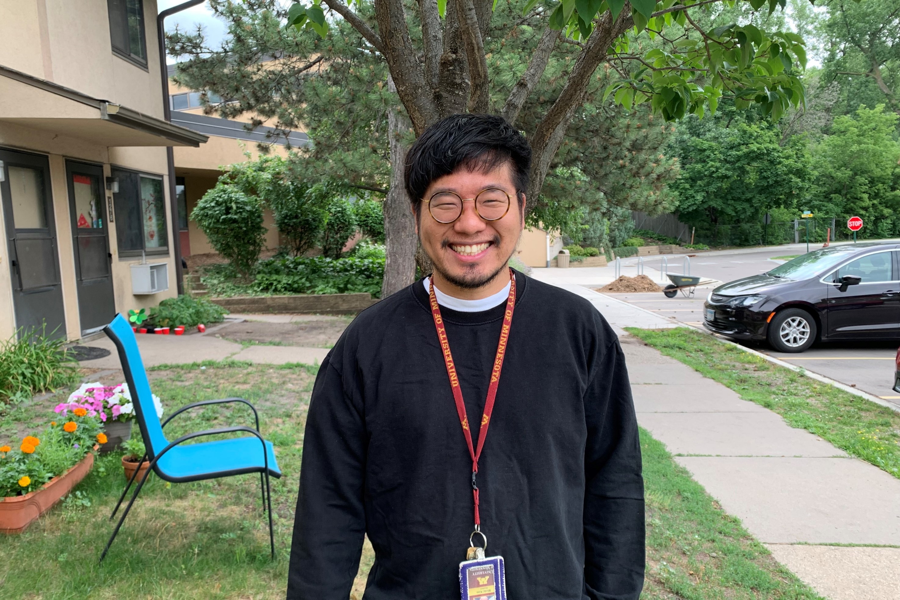 Doctoral student Minki Kim standing outdoors on a lawn