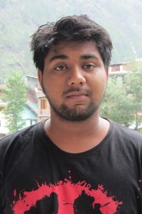 Mohit standing outside wearing a black and red t-shirt