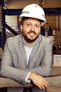 Pedram Mortazavi in lab wearing a hard hat