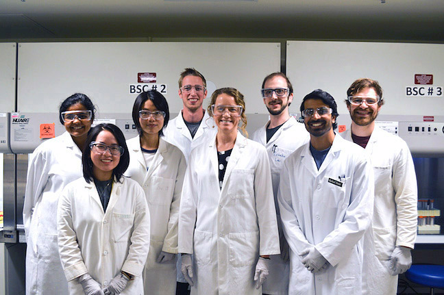 Professor Reineke and seven students in lab coats.