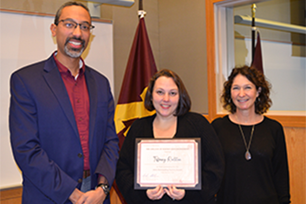Tiffany Ralston (center) holds her certificate. She is flanked by Andrew Alleyne and Deaprtment Head Paige Novak.