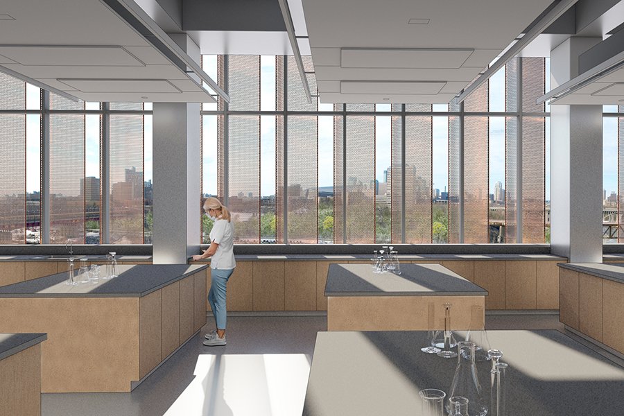 student standing in a future chemistry lab in an architectural rendering