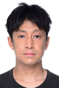 Picture of person with black hair in front of a white background