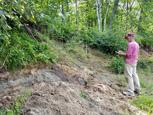 Quaternary Geologist, Alan Knaeble, documenting an exposure of glacial sediment in Aitkin County.