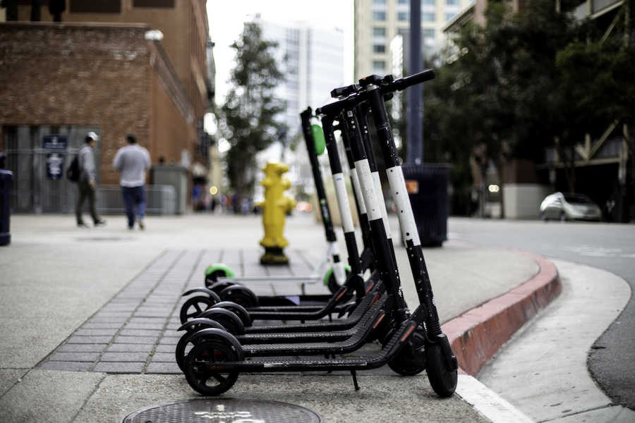 Stock photo of electric scooters parked on a curb