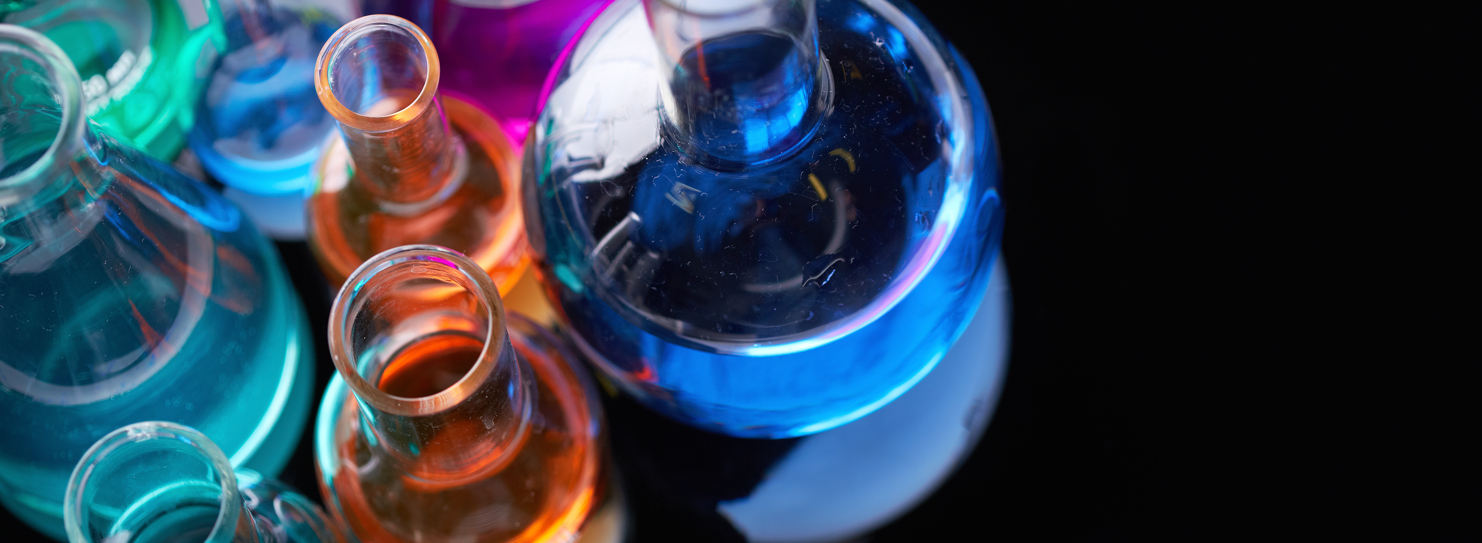 Image of several flasks with multicolor chemical liquids.