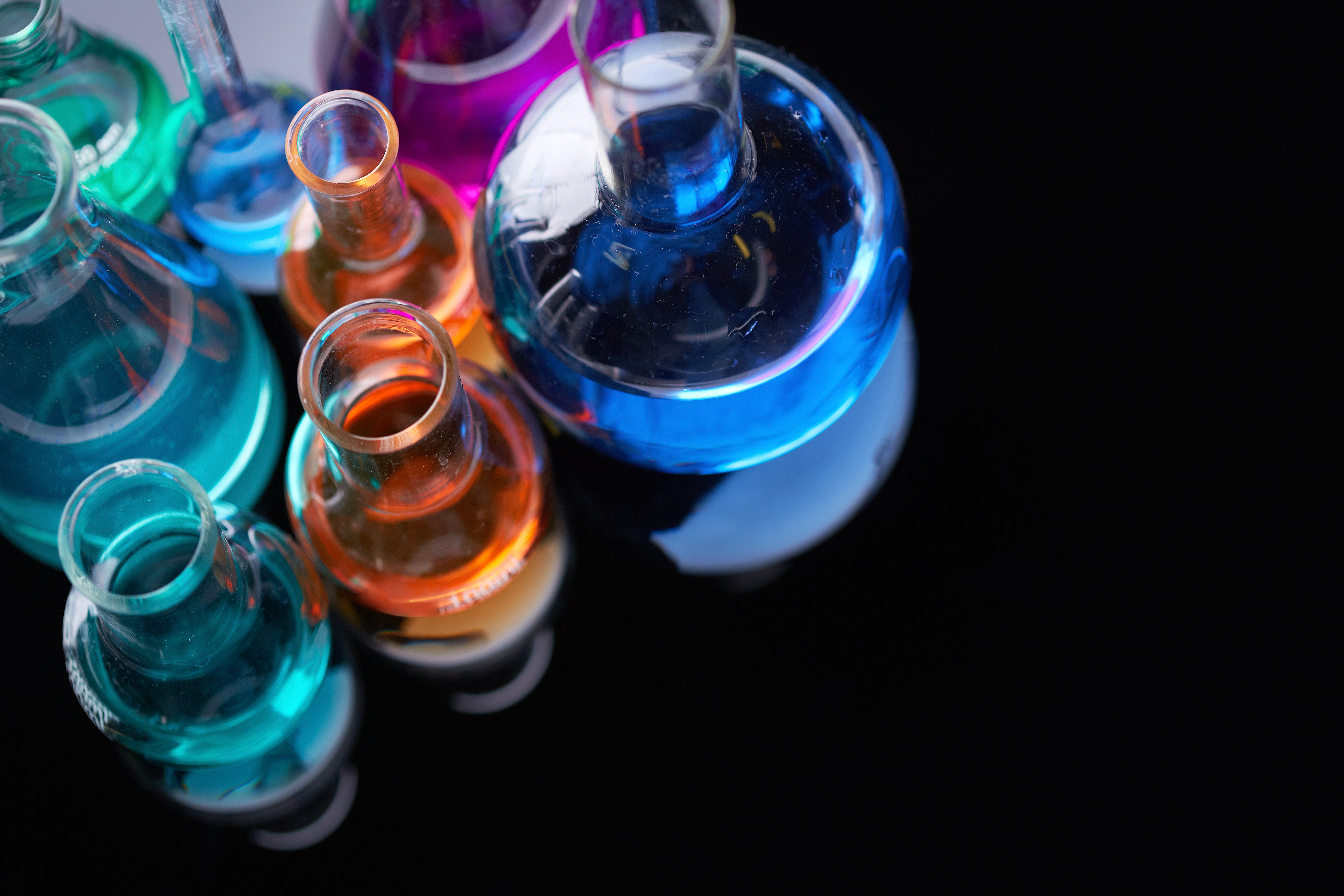 image of several flasks with multicolor chemical liquids