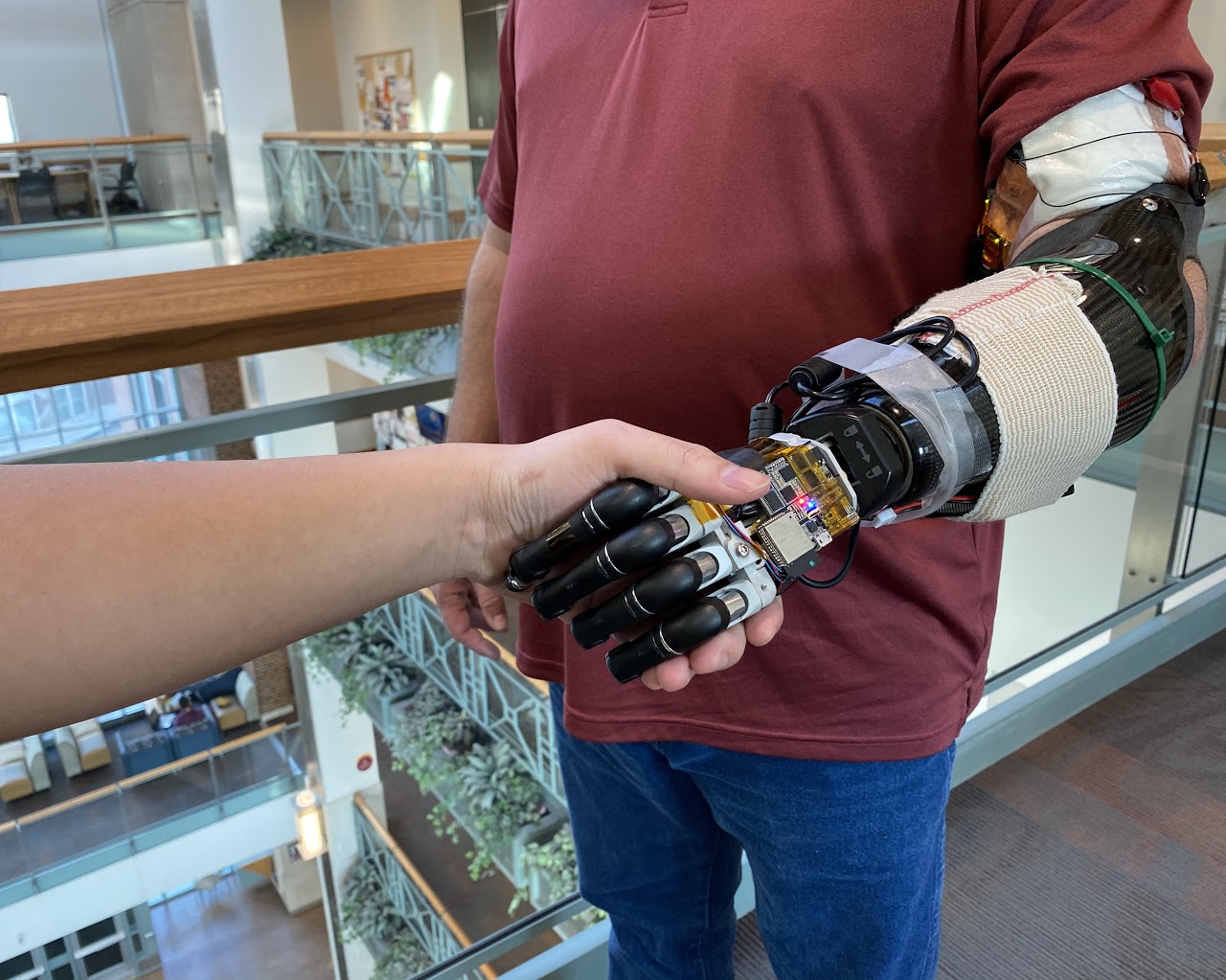 Hand touching a robotic arm