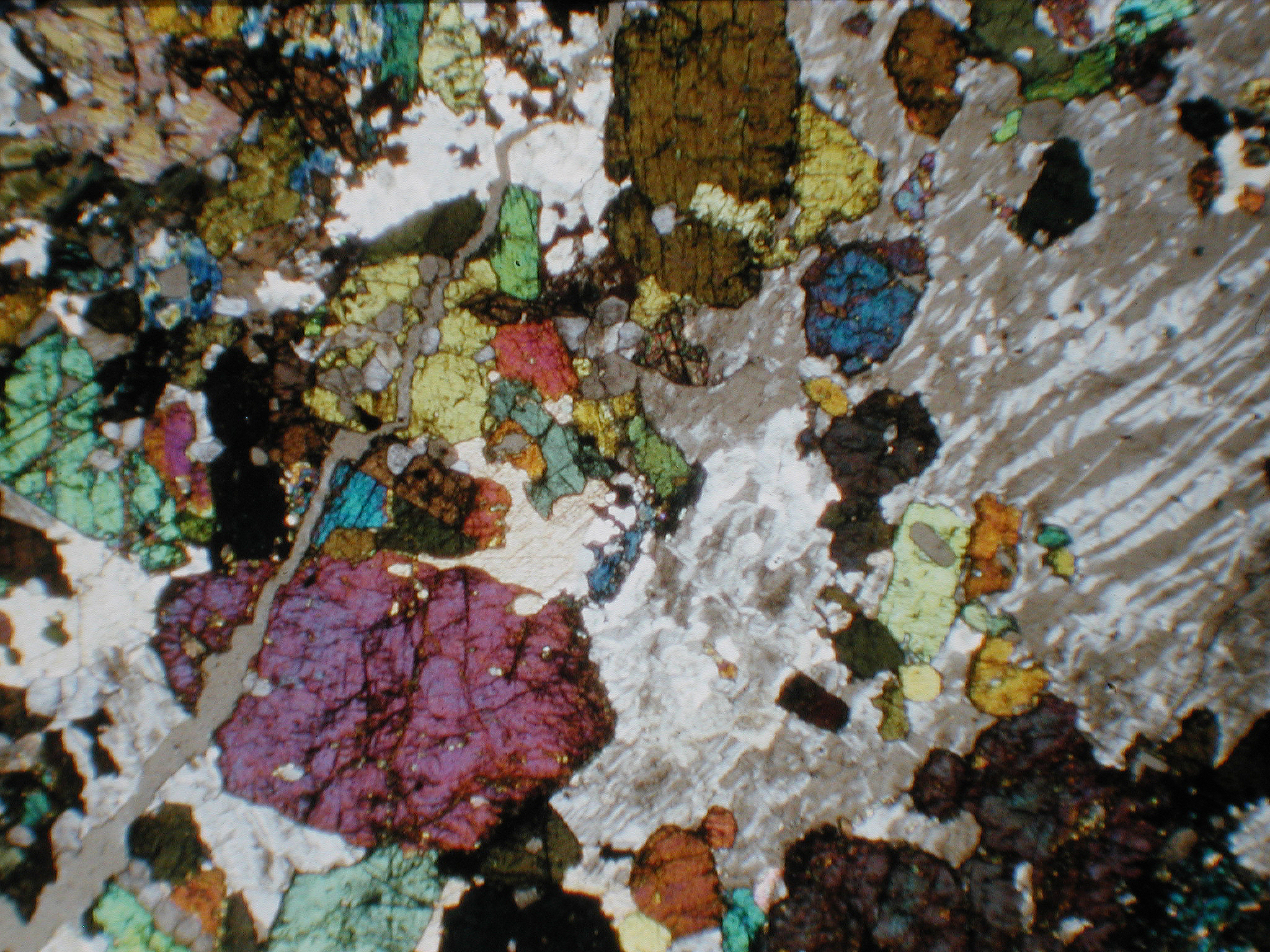 Thin section image in cross-polarized light under a microscope.