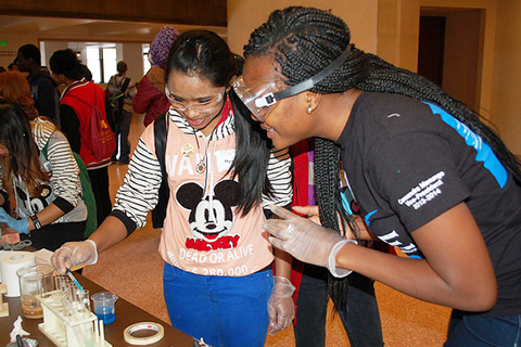 Students with goggles on interacting with chemical at CSE expo