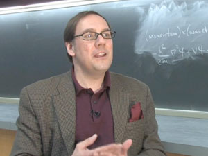 James Kakalios talking in front of blackboard