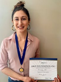 Mariah Dorner holding her ARCS certificate