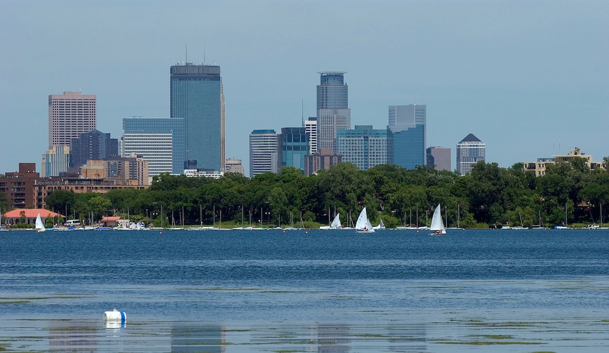 Boats on Bde Maka Ska with Minneapolis skyline in the distance