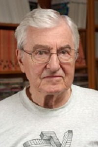 Man with glasses, white hair and a white t-shirt