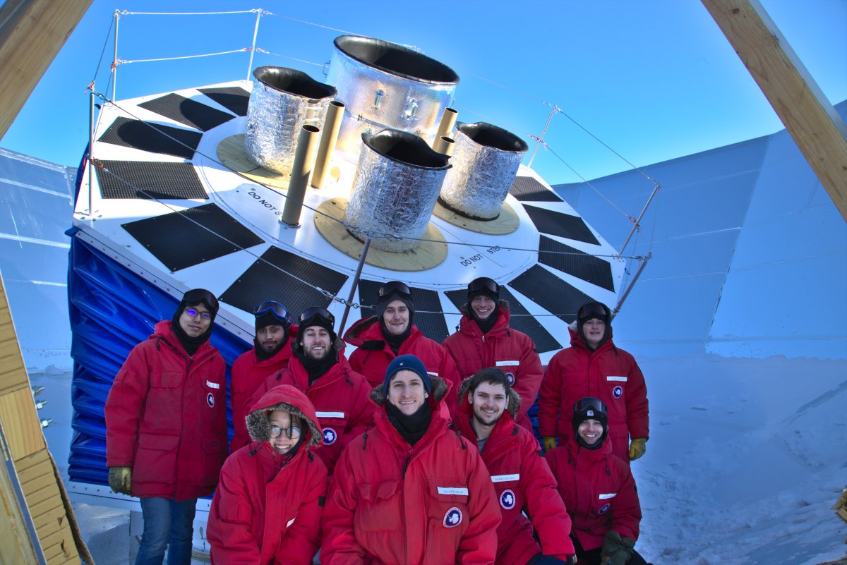 The BICEP Array team stands before the composite of four telescopes that make up the BICEP Array