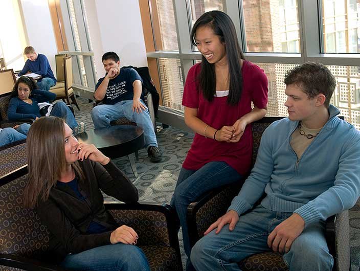 Three students talking in student housing