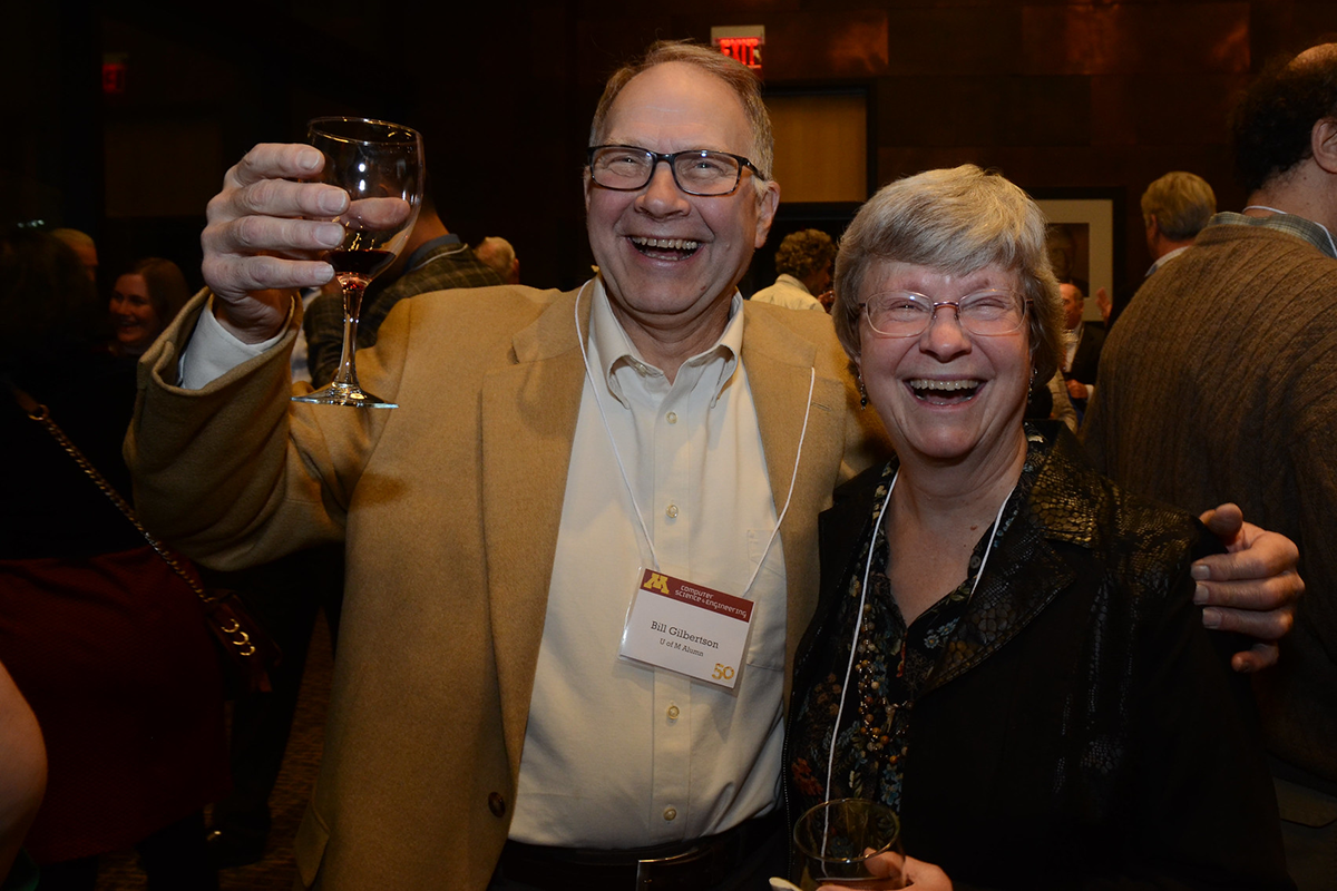 A male and female alumni celebrating at the 50th anniversary event
