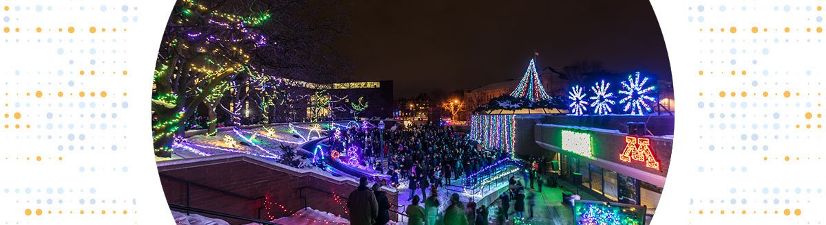 Photo of holiday lights in the Winter Light Show with people gathered to watch in the snow