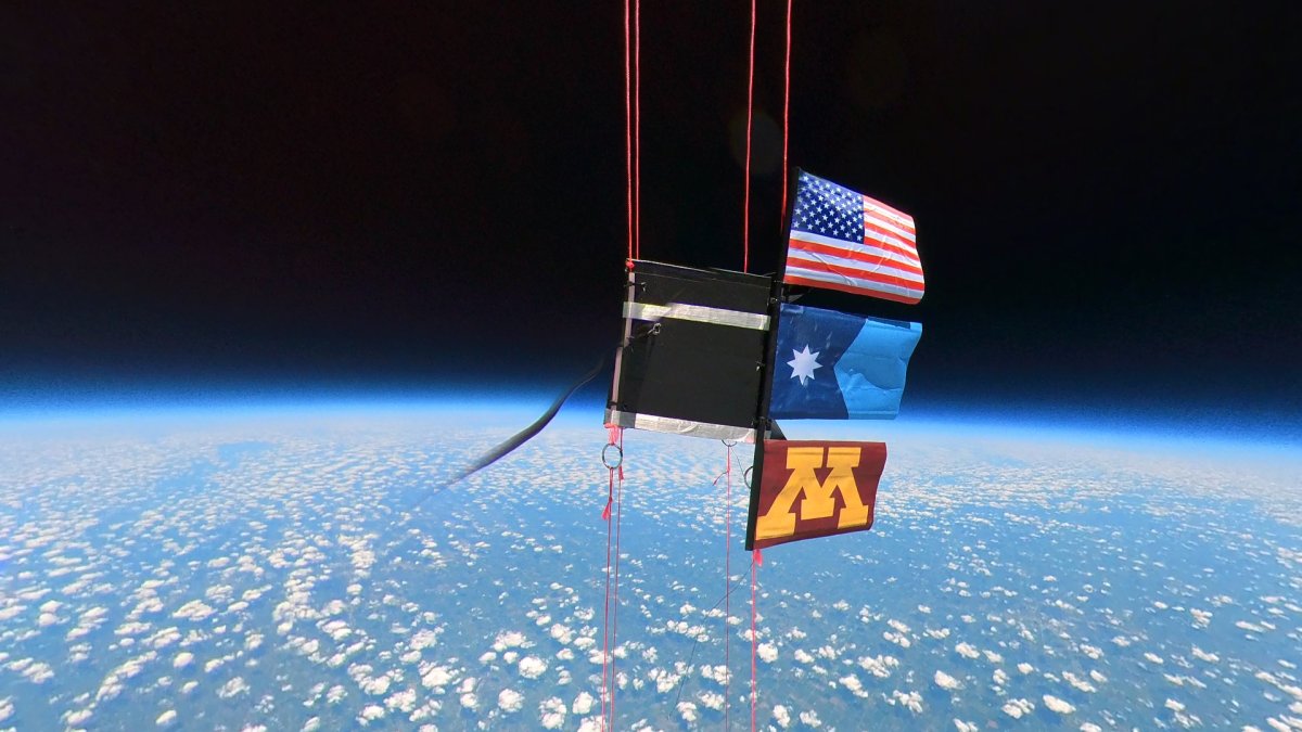 picture of american flag, minnesotan flag, and U of M flag in outer space