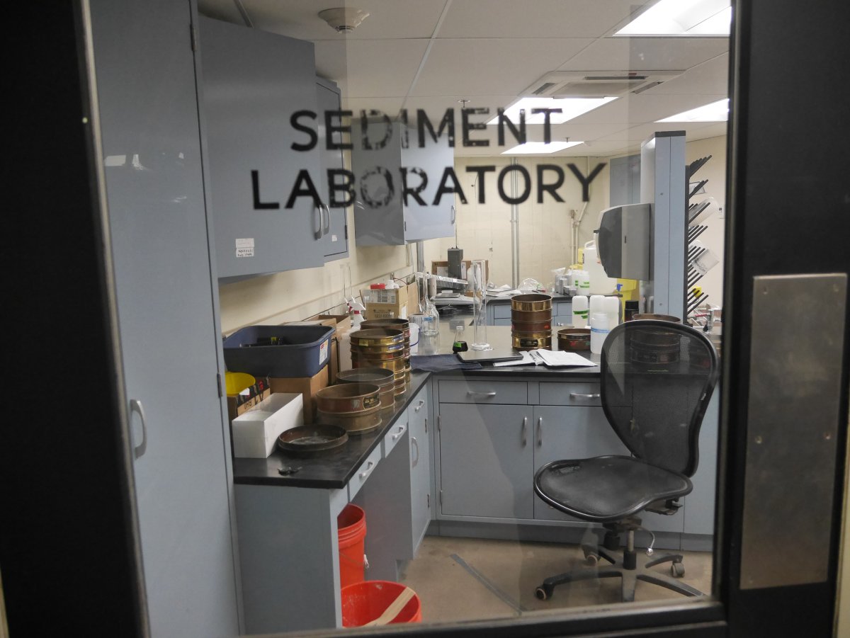 Photo of the sediment laboratory through a labeled glass window