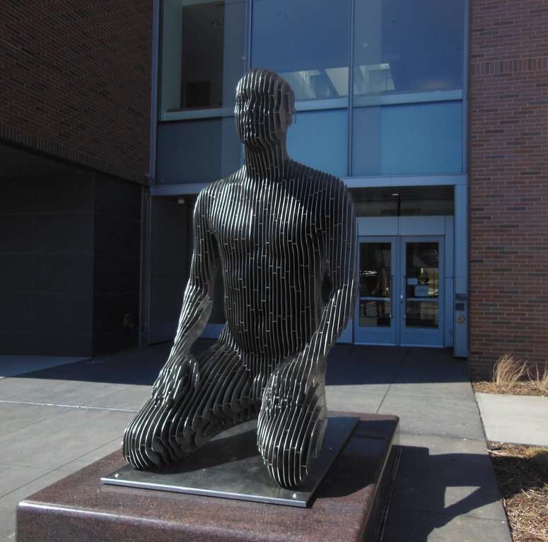 One half of the outdoor sculpture Spannungsfeld by Julian Voss-Andrae, sitting outside the Physics and Nanotechnology Building.