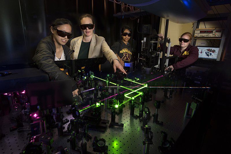 Professor Renee Frontiera in laser lab with students