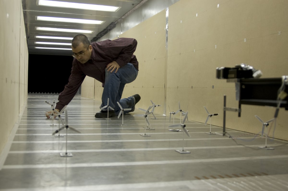 Photo of Wind Tunnel with a scientist adjusting small turbine models