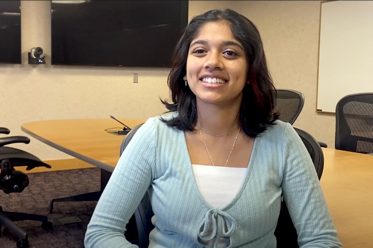 Sadhika Prabhu sitting in a conference room.