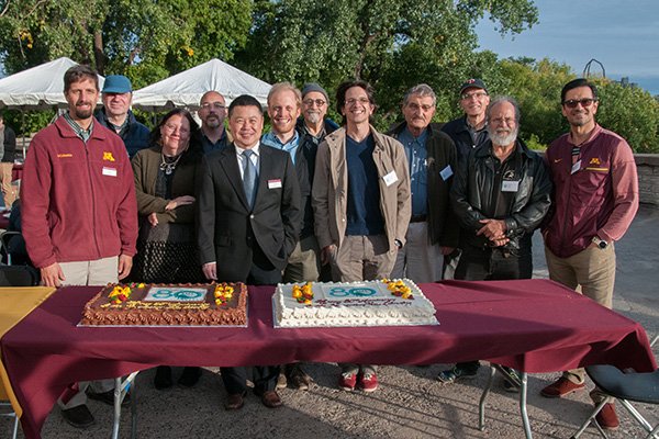 SAFL leadership around 80th anniversary cake at alumni picnic