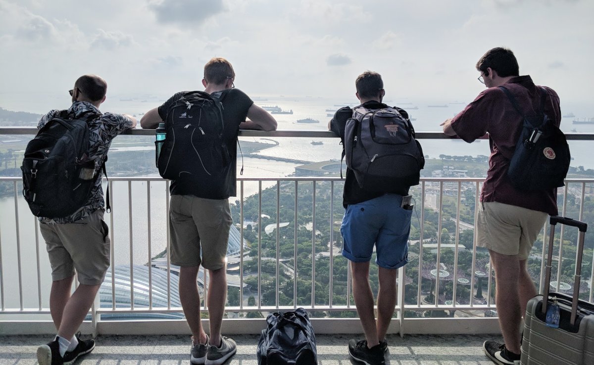 Four students looking at the Singapore skyline