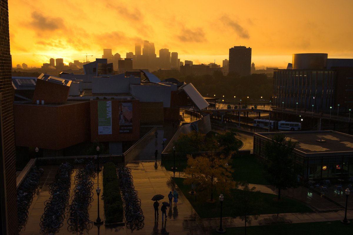 Weisman Art Museum foregrounded by city skyline on a rainy day