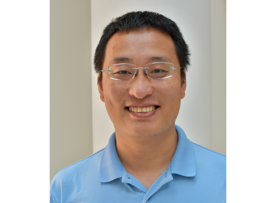 Zhen Liiu smiling man in glasses and a blue polo shirt