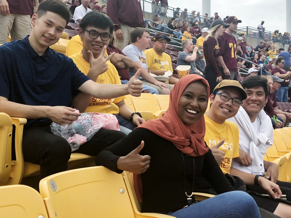 Diverse group of students at a football game