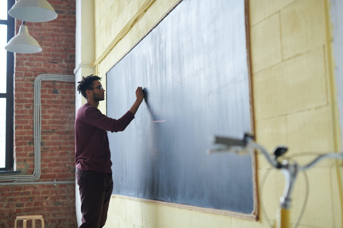 Man writing on blackboard