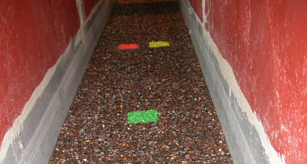 Sediment transport flume with different colored squares of pebbles